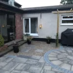 back garden with stones and concrete pavement